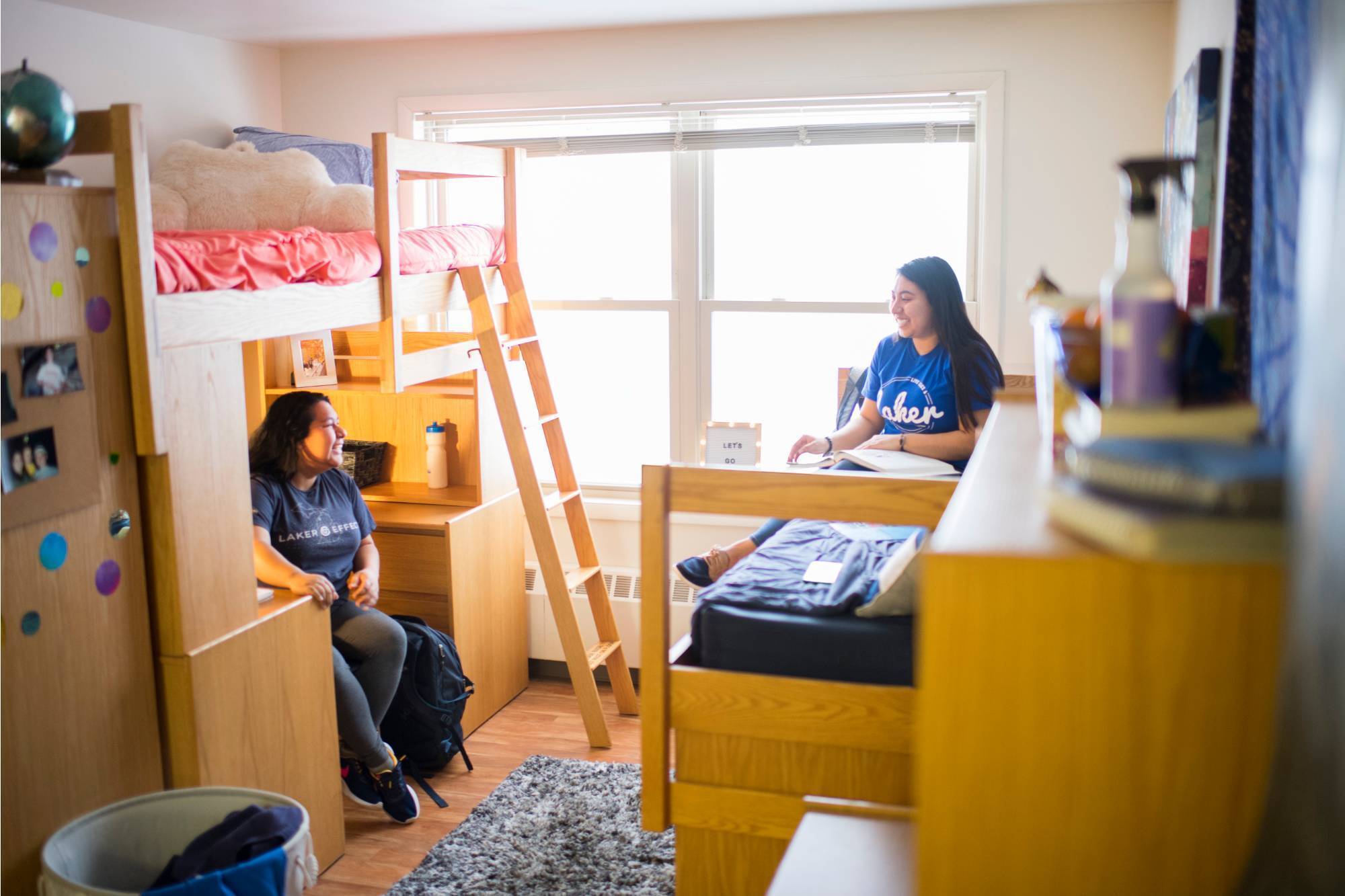 Students having a casual conversation in their dorm room